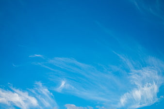 Vibrant blue sky with wispy white cirrus clouds