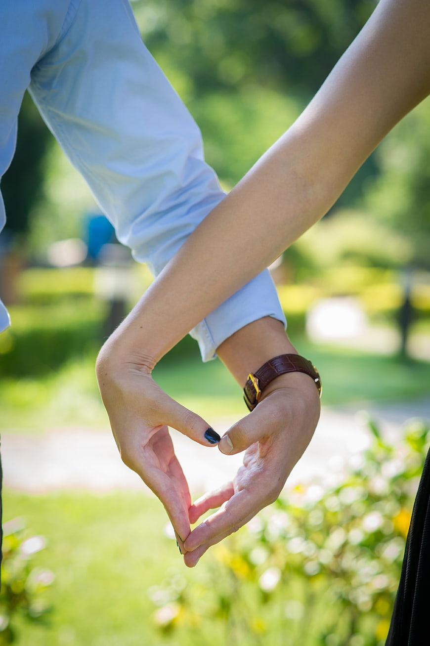 Couple Making Heart Shape with Hands in Park
