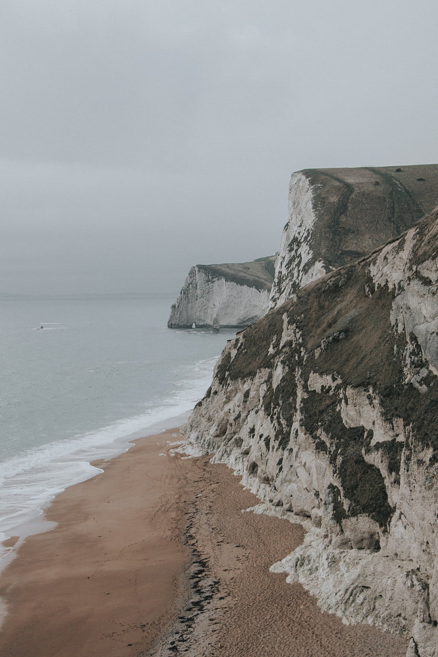 Dramatic white cliffs and sandy beach on an overcast day