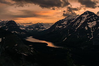 Dramatic Sunset Over Snowy Mountain Valley and Lake