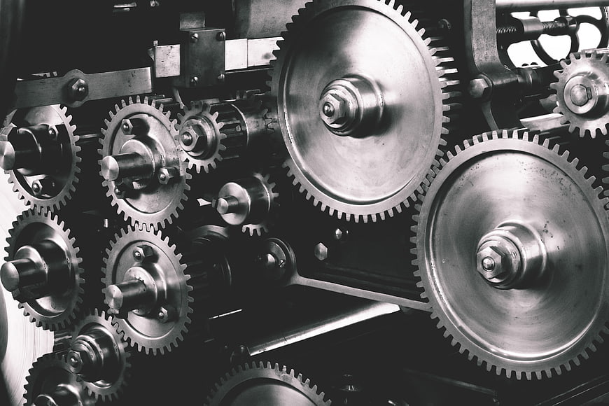 Close-up of industrial metal gears and cogs in motion