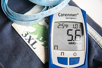 Blood Glucose Meter And Measuring Tape On Denim Fabric