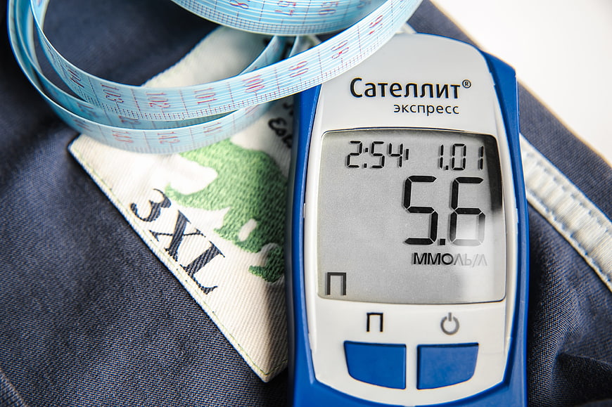 Blood Glucose Meter And Measuring Tape On Denim Fabric