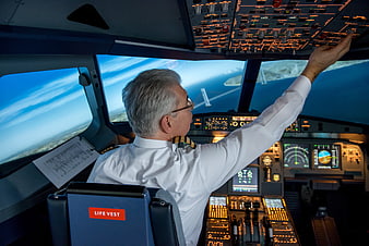 Senior Pilot Operating Aircraft Cockpit Controls