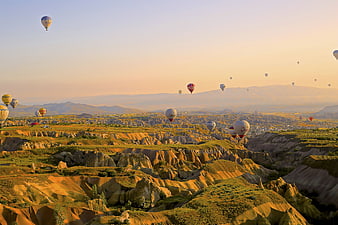 Hot Air Balloons Flying Over Cappadocia Landscape at Sunrise