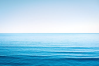 Serene Blue Ocean Horizon with Calm Waves and Clear Sky