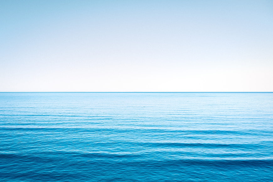 Serene Blue Ocean Horizon with Calm Waves and Clear Sky