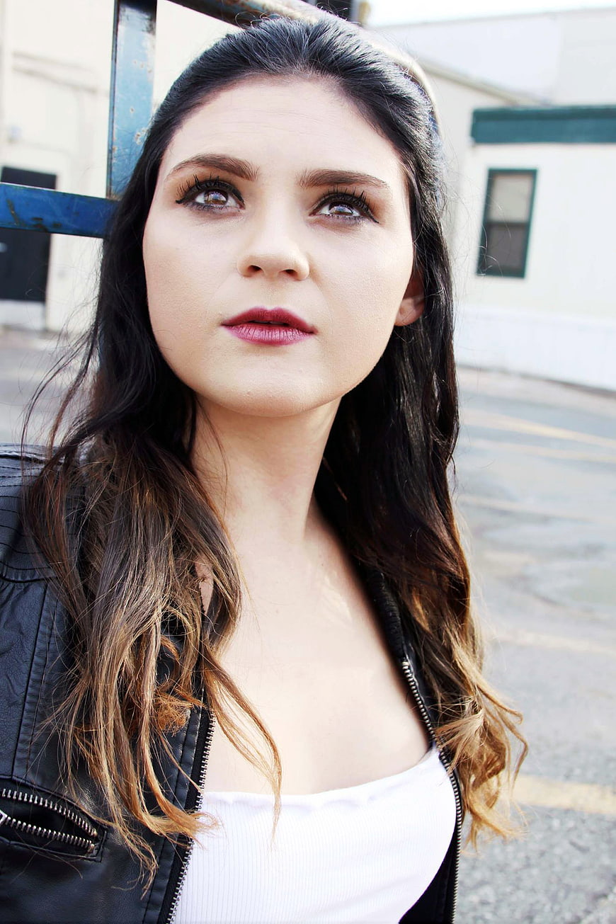 Portrait of Young Woman in Leather Jacket Looking Up