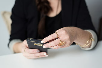 Woman's Hands Using Smartphone with Gold Jewelry