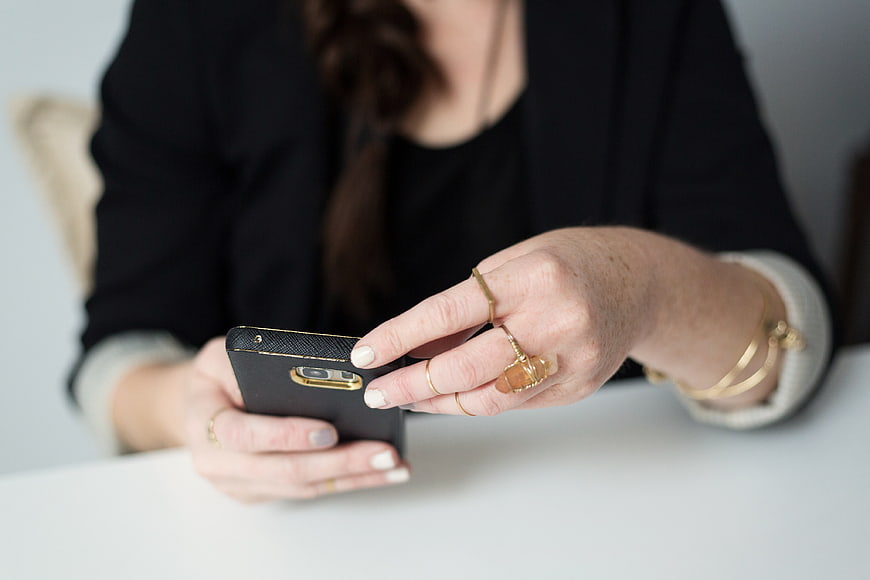 Woman's Hands Using Smartphone with Gold Jewelry