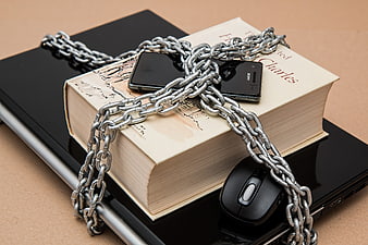 Concept of censorship with chains binding books and technology