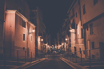 Empty European Street at Night with Warm Streetlights