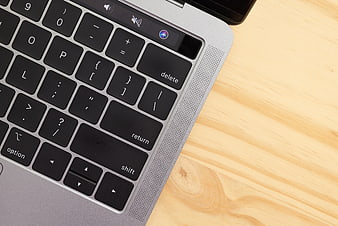 Close-up of laptop keyboard on wooden desk