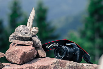 DSLR Camera and Rock Cairn in Nature