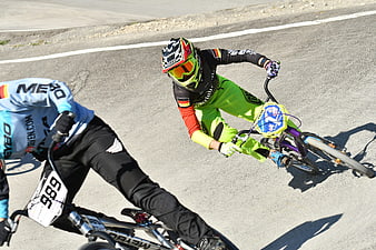 BMX Cyclists Racing on Asphalt Track