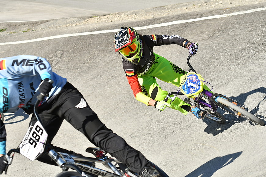 BMX Cyclists Racing on Asphalt Track