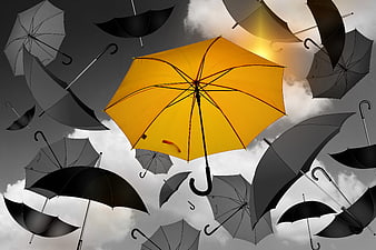 Yellow Umbrella Floating Among Black Umbrellas Against Cloudy Sky