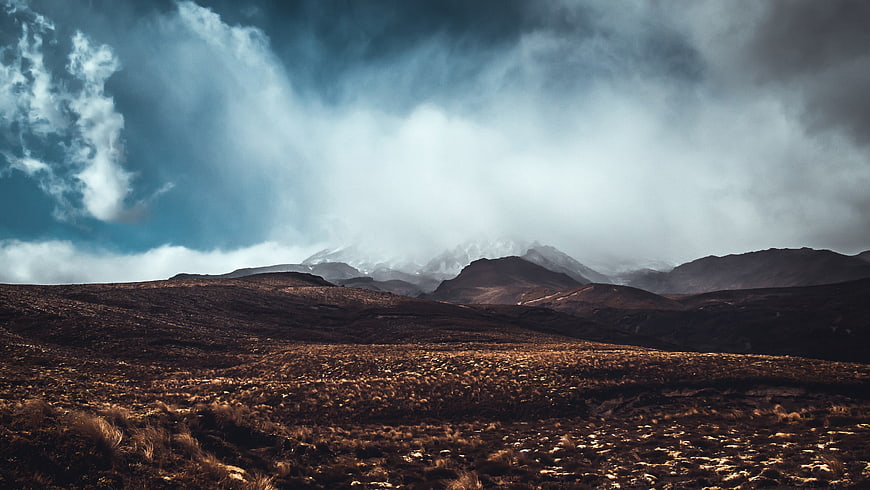 Dramatic Mountain Landscape with Stormy Clouds and Golden Grass
