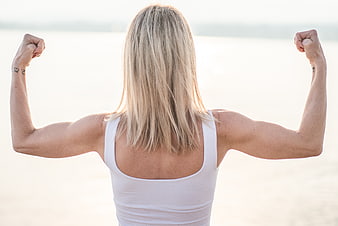 Strong Woman Flexing Muscles Back View