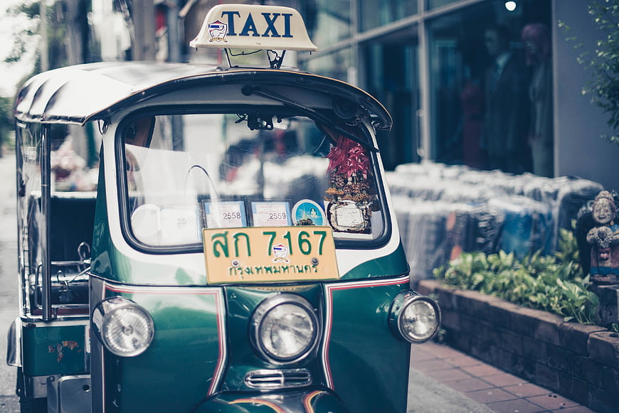 Green Thai Tuk-Tuk Taxi on City Street
