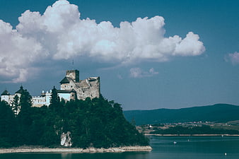 Orava Castle on a Hill Overlooking Lake and Mountains