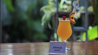Fresh Orange Juice Cocktail with Garnish on Wooden Table