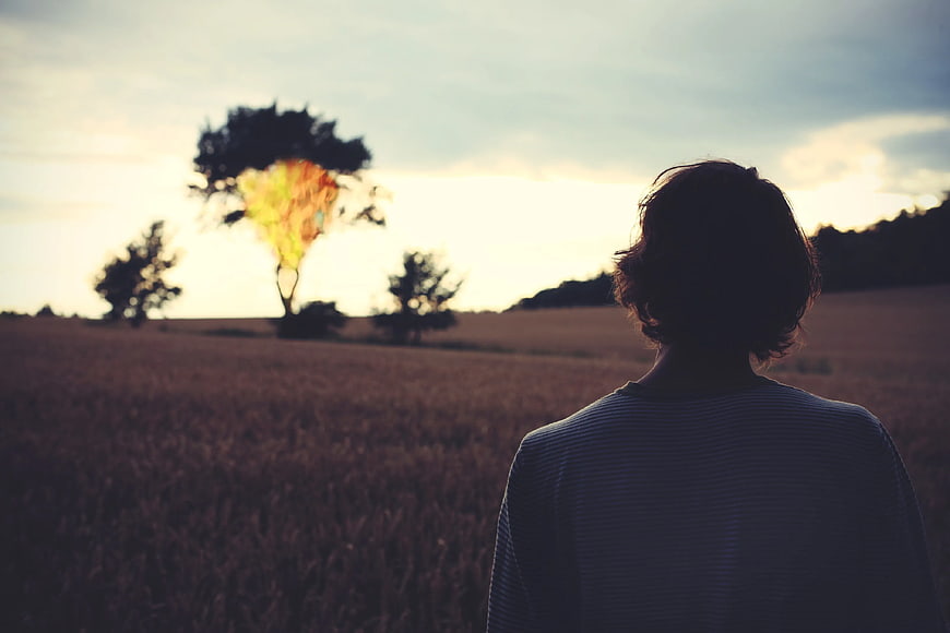 Woman Silhouette in Wheat Field at Sunset