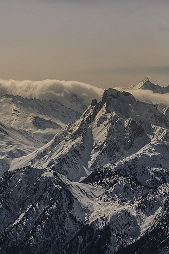 Majestic Snow-Covered Mountain Peaks with Clouds