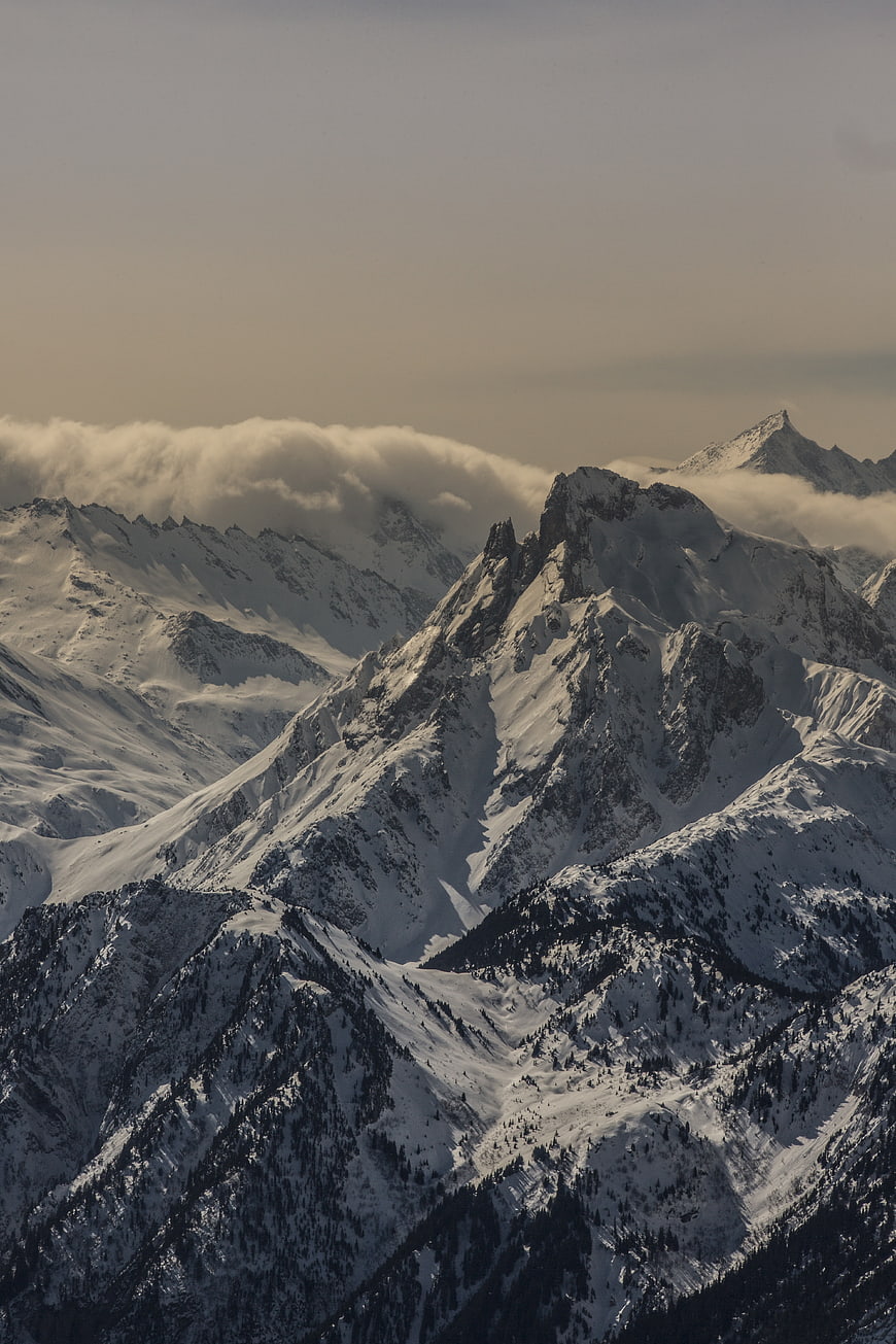 Majestic Snow-Covered Mountain Peaks with Clouds