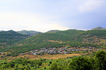 Rural village nestled in green mountain valley landscape