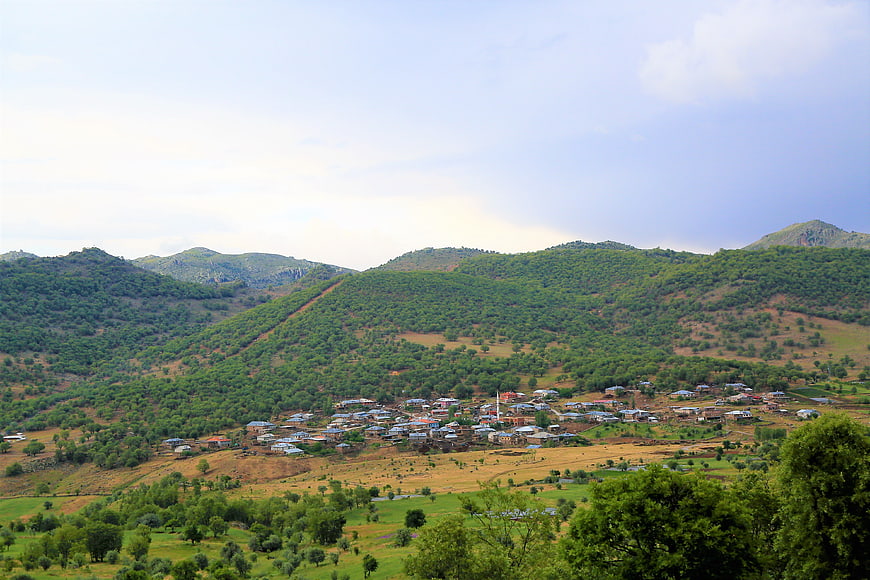 Rural village nestled in green mountain valley landscape