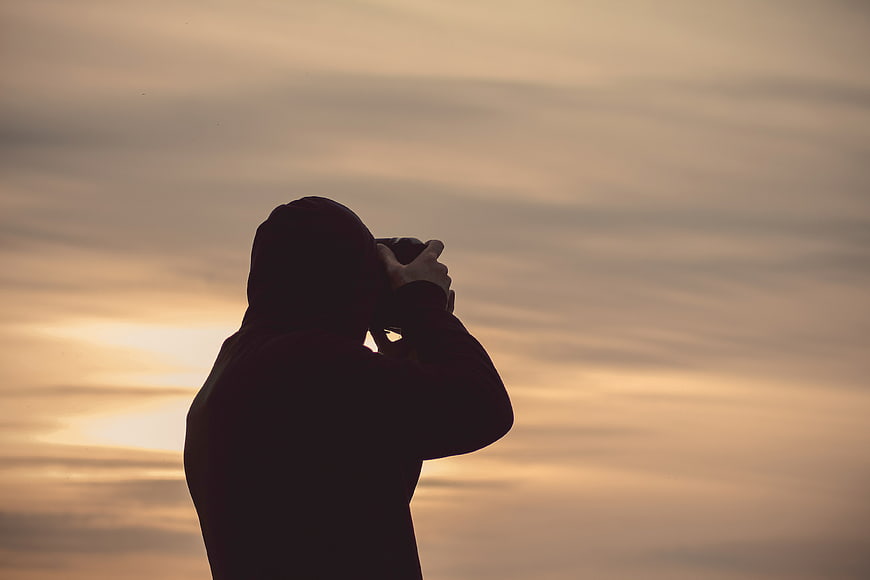 Silhouette of Photographer Taking Photo at Sunset