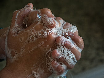 Close-up of hands covered in soap bubbles