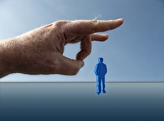 Hand flicking away blue business figurine concept