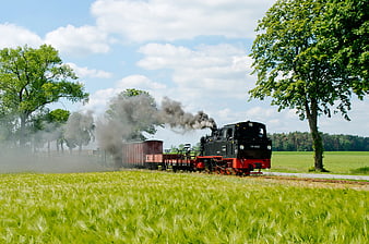 Vintage Steam Train Traveling Through Green Countryside