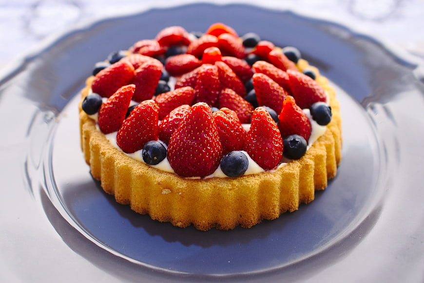 Fresh Strawberry and Blueberry Tart on Blue Plate
