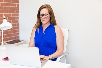 Professional woman working on laptop in modern office