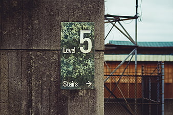 Weathered Level 5 Stairs Sign on Concrete Wall
