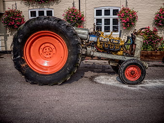 Vintage Tractor with Large Orange Wheels and Exposed Engine