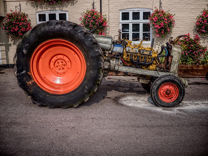 Vintage Tractor with Large Orange Wheels and Exposed Engine