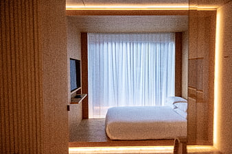 Modern Minimalist Hotel Bedroom Interior with Warm Lighting