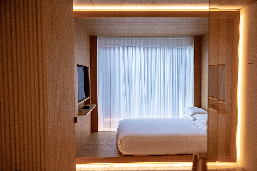 Modern Minimalist Hotel Bedroom Interior with Warm Lighting