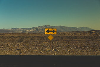 Yellow Road Sign in Arid Desert Landscape