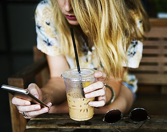 Woman with Iced Coffee and Smartphone at Cafe