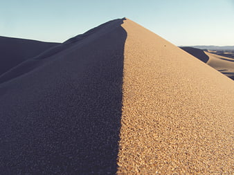 Close-up of sand dune ridge with sharp shadow contrast