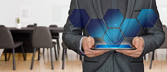 Businessman holding tablet with blue hexagon hologram projection