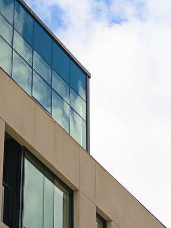 Modern Glass Office Building Facade with Blue Sky