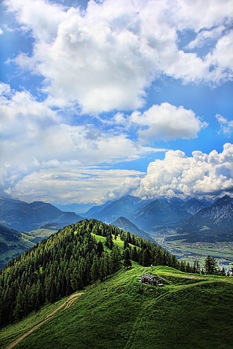 Panoramic Alpine Mountain Landscape with Hut and Clouds