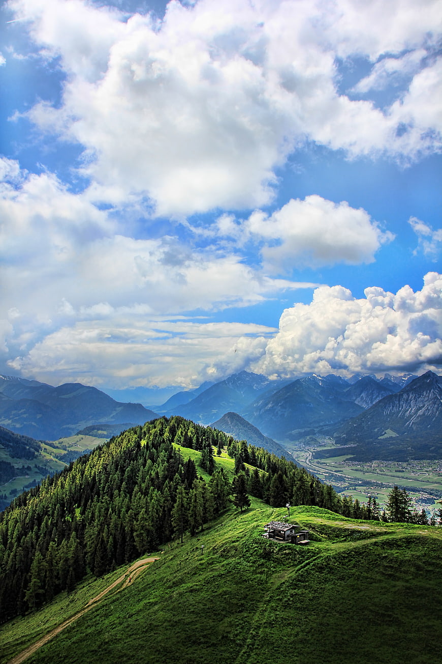 Panoramic Alpine Mountain Landscape with Hut and Clouds