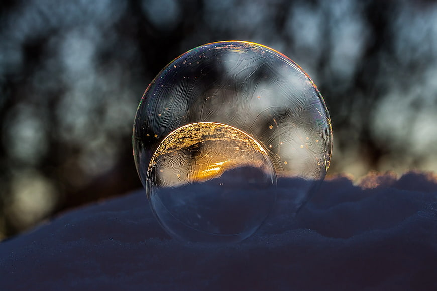 Frozen Soap Bubble with Golden Light on Snow